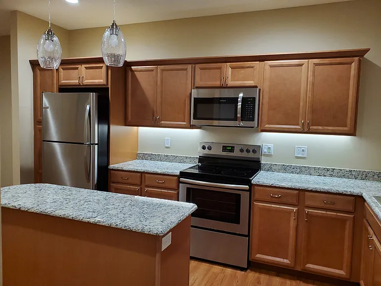 Spacious kitchen with granite countertops and work island.