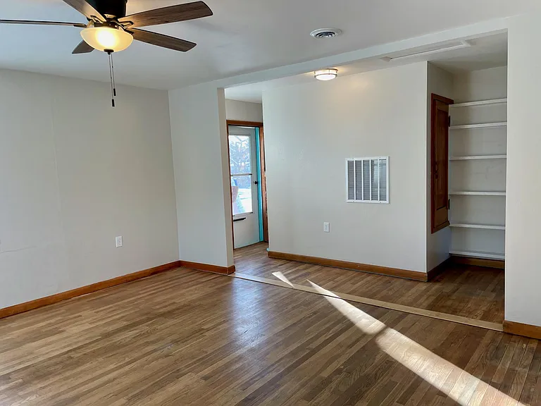 Family Room to Spaulding St door, built-in shelves, and classic storage closet