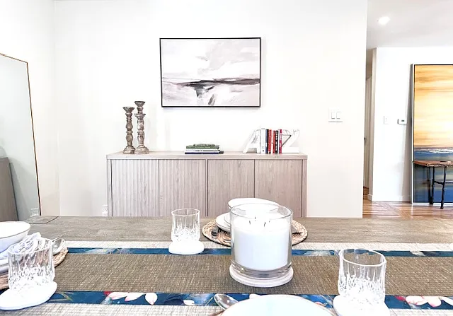 Farmhouse style dining room with tasteful furniture and decor.