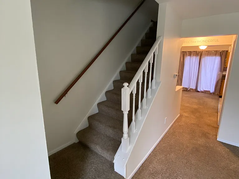 Living room looking into apartment. Steps to upstairs.