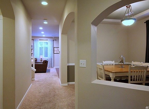 Entering the hall you see the dining room on the right, the powder room on the left and access to the garage is by the powder room for quick cleanups.
