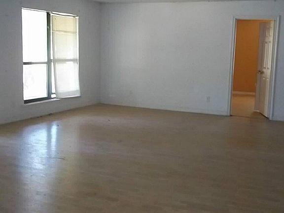 WOOD FLOORING AND FRENCH DOORS LEADING OUT TO COVERED DECK