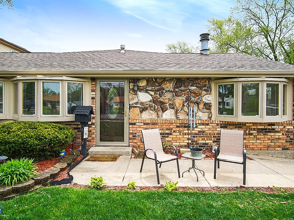 View of the front of the house with bay windows.  The house is larger than it looks.  The master bedroom has the bed area and a 