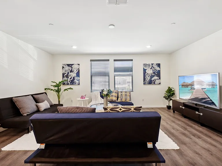 Relax and unwind in the living room with a comfy sofa and TV for ultimate comfort.