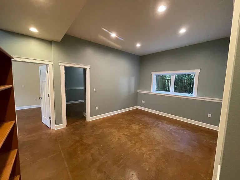 First floor media room - stained concrete floors stay cool in the summer and warm in the winter with radiant floor heat