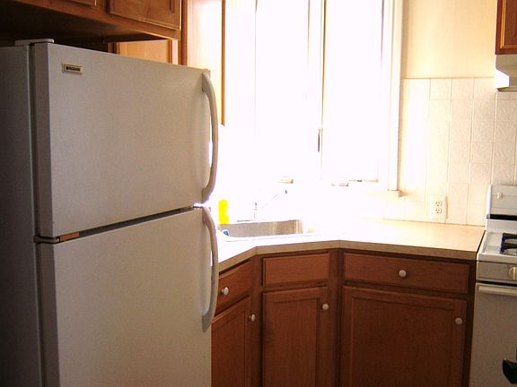 Refrig and corner kitchen sink and sunny window
