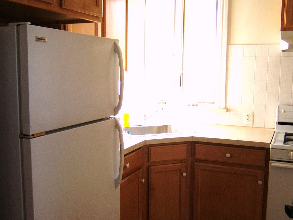 Refrig and corner kitchen sink and sunny window