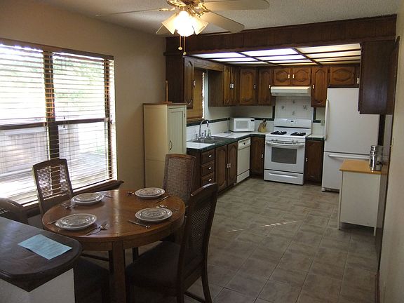 Dining area leads to kitchen.
