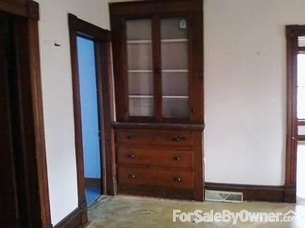 Dining room with china cabinet pass-thru
						:
						floor-ceiling pantry- cabinet. opposite - wbstove. r door is br, mid kit l. bath