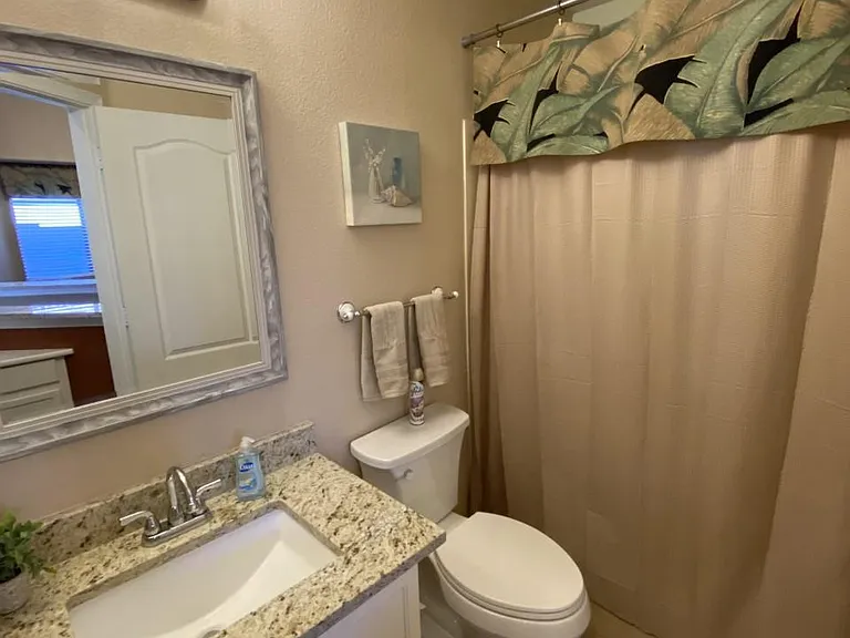 Another full bathroom tiled with new granite and contemporary square sinks plus new plumbing and lighting and ADA toilet and custom matched shower!