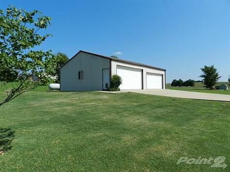 Detached 4 car garage/workshop and 230' cement driveway..