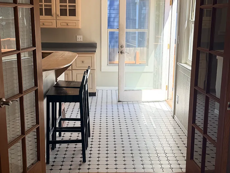 french doors to kitchen area. booth seating at kitchen