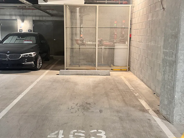 underground parking garage with private reserved spot next to elevator