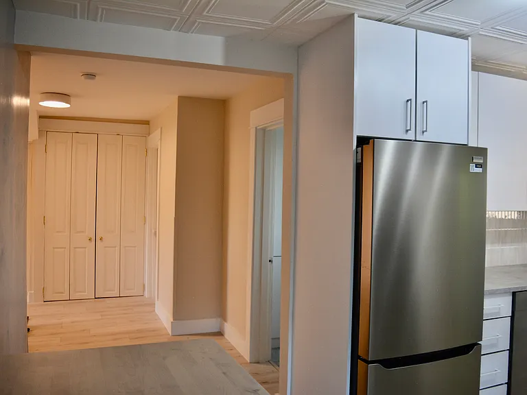 Looking into the living area; straight ahead is the laundry room and the door to the right is the bathroom