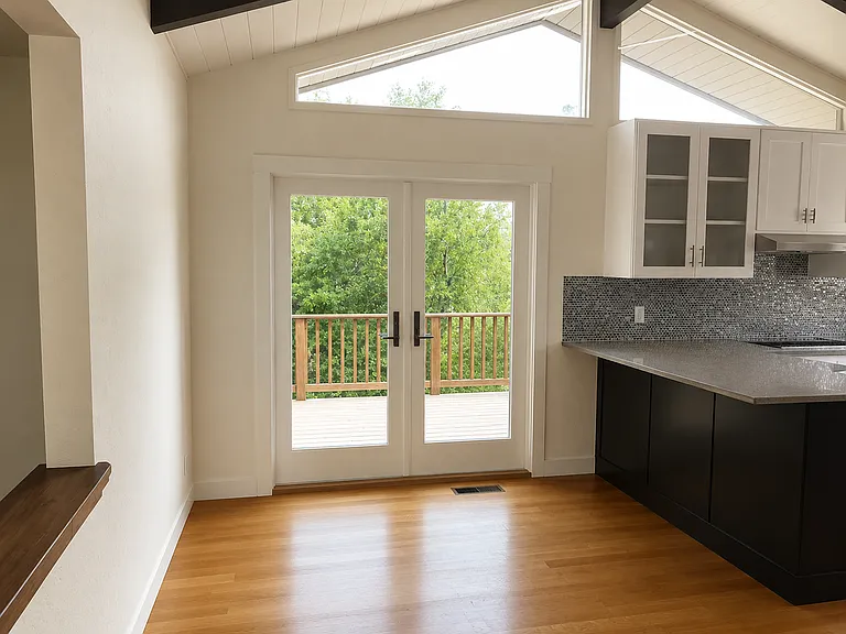 Kitchen area with french doors leading to the upper deck.