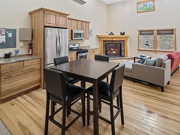 Roomy living area with custom mantle and gas fireplace