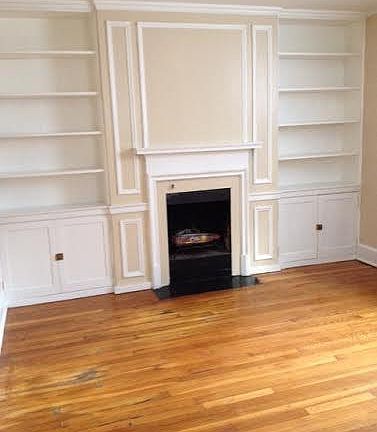 fireplace flanked with original bookshelves