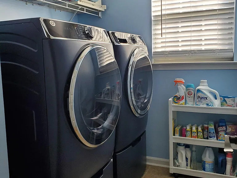 Laundry room with 1 yr old front load GE Ultrafresh washer and dryer conveniently located upstairs near all the bedrooms and bonus room.