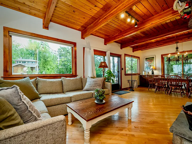 Spacious open layout featuring hardwood floors, vaulted ceilings, and a comfortable flow between living and dining areas.