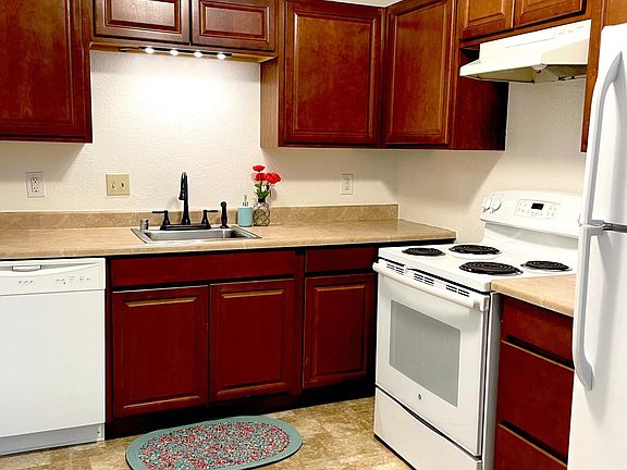 Kitchen includes full-sized stove/refrigerator, dishwasher, and garbage disposal.
