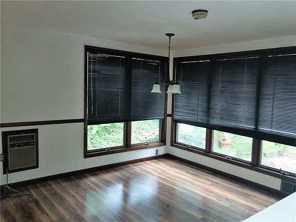 Huge breakfast room are with beautiful wall of windows looking onto the patio and new light fixture.