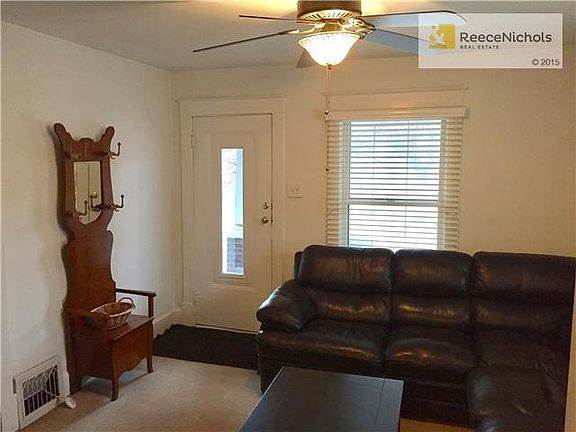 Beautiful antique front door, new, modern ceiling fan and openness.