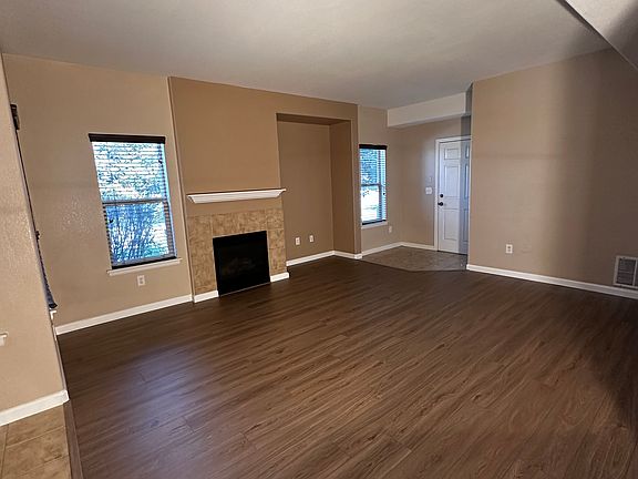 Living room w/fireplace, entertainment nook, and door to garage