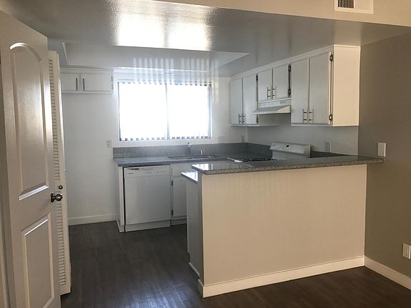 Open downstairs floor; kitchen opens to dining room and livi