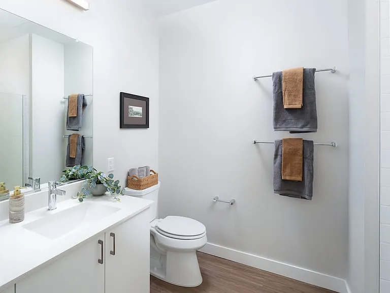 Design Collection I bath with white quartz countertop, white cabinetry, standing shower, and hard surface flooring