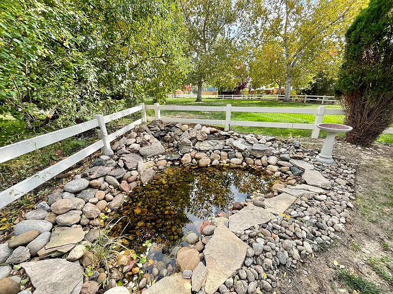 Tranquil pond with Colorado moss rock and waterfall