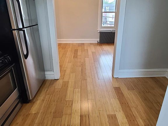 View of apartment entry and kitchen looking into living room area
