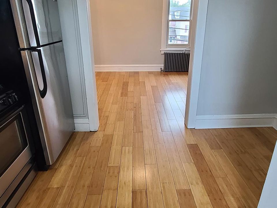 View of apartment entry and kitchen looking into living room area