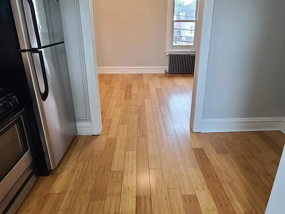 View of apartment entry and kitchen looking into living room area