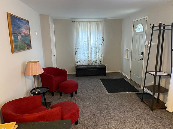 Near end of a living space that is the first room entered through the front door; this room leads to the kitchen