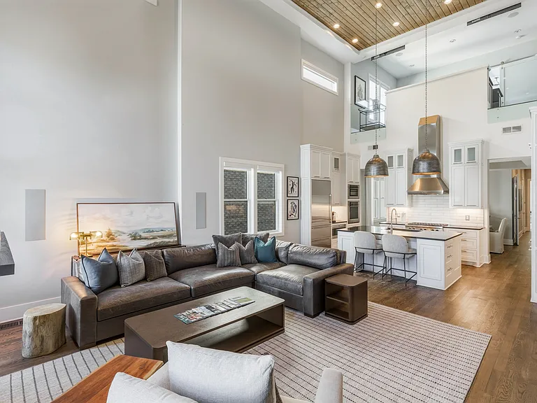 Bright, modern living room with HUGE ceilings. Abundant natural light, plush seating for everyone, a cozy gas fireplace, and a Smart TV_perfect for relaxing.