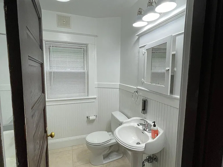 Claw-foot tub/shower combo and pedestal sink newly painted with new lighting, fan and electrics.