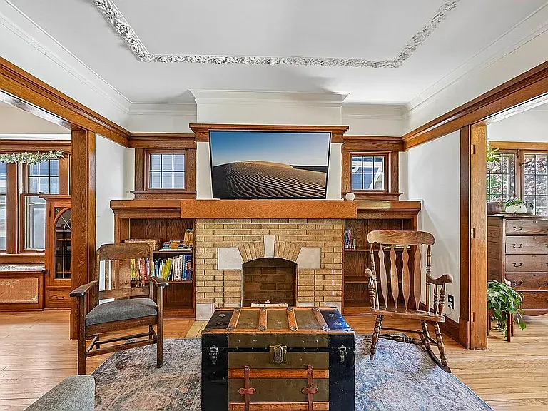 Living room, looking towards fireplace (tv mounting hardware already set up, fireplace is not operable).