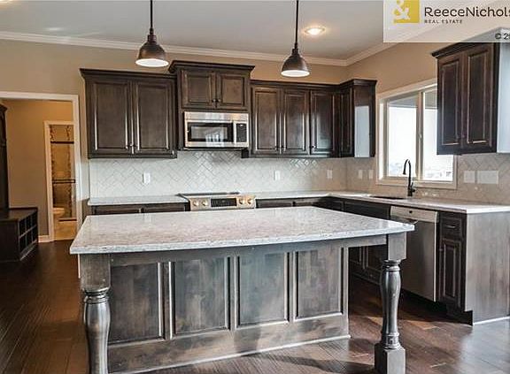 Kitchen includes: Granite counter tops, Kholer oil rubbed bronze kitchen faucet with integral sprayer, Bosch stainless steel appliances: range, dishwasher, microwave. Concealed cabinet door hinges, Soft-close drawers with designer pulls, and USB charging 