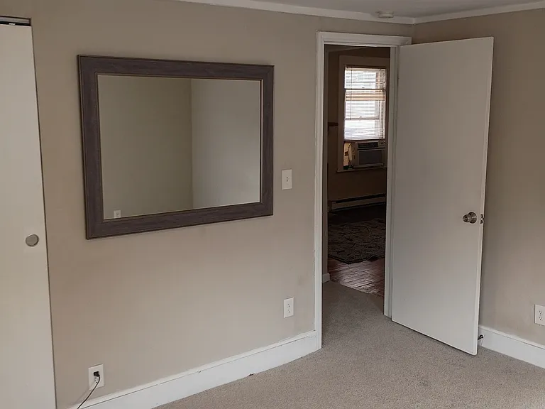bedroom with large hanging mirror