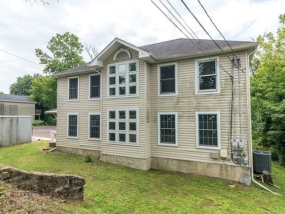 Front exterior - set off the road and behind the "grand gray lady of the 1860's". Private location with off street parking.