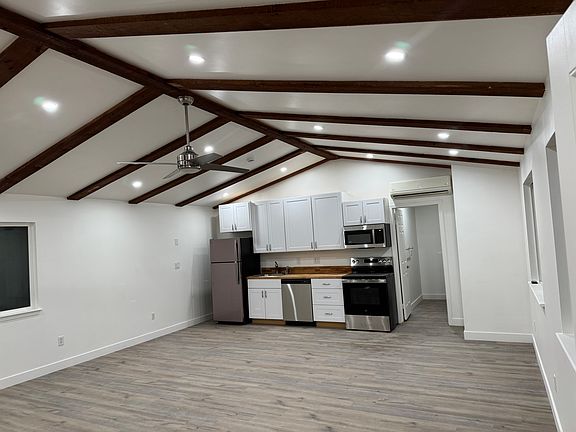 View from entry door towards kitchen. Open Beam Ceilings, new LED lighting, ceiling fan