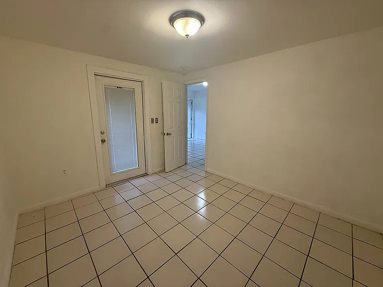Private bedroom with tile flooring, neutral finishes and ample space for a comfortable bedroom setup.