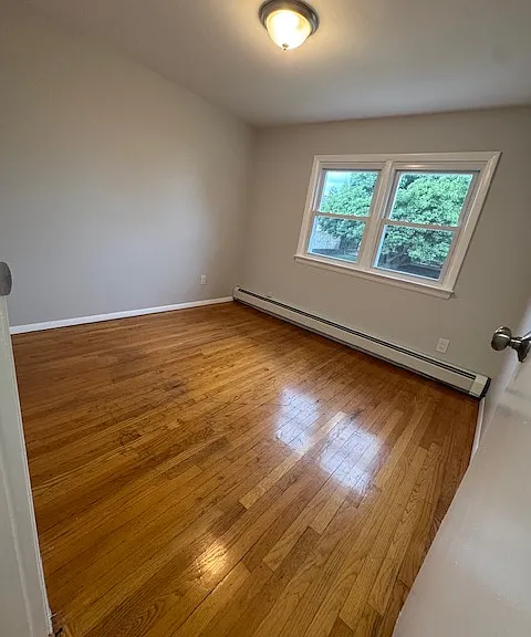 Bedroom 1: features natural lighting, hardwood floors and closet