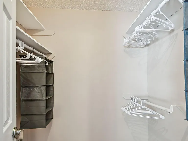 Oversized walk in closet with plenty of storage