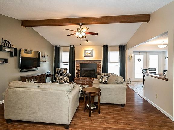A spacious vaulted living room greets you with a semi-open floor plan. Cozy up to the NEW gas fireplace that was recently installed. Separate dining room is to the right.