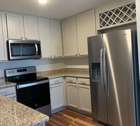 Painted cabinets with a Whirlpool Stainless Steel appliance package