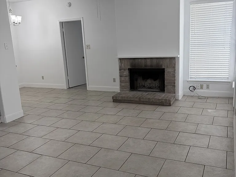 Living area from front door, fireplace, dining area and kitchen to left, door to Primary bedroom