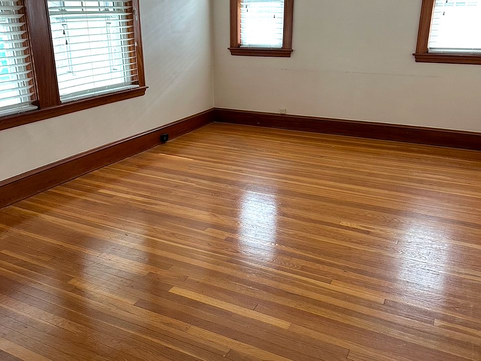 Living room with an abundance of natural light throughout with gleaming hardwood floors.