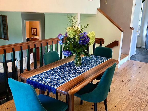 Open dining room, overlooking the sunken living room with view of back yard.