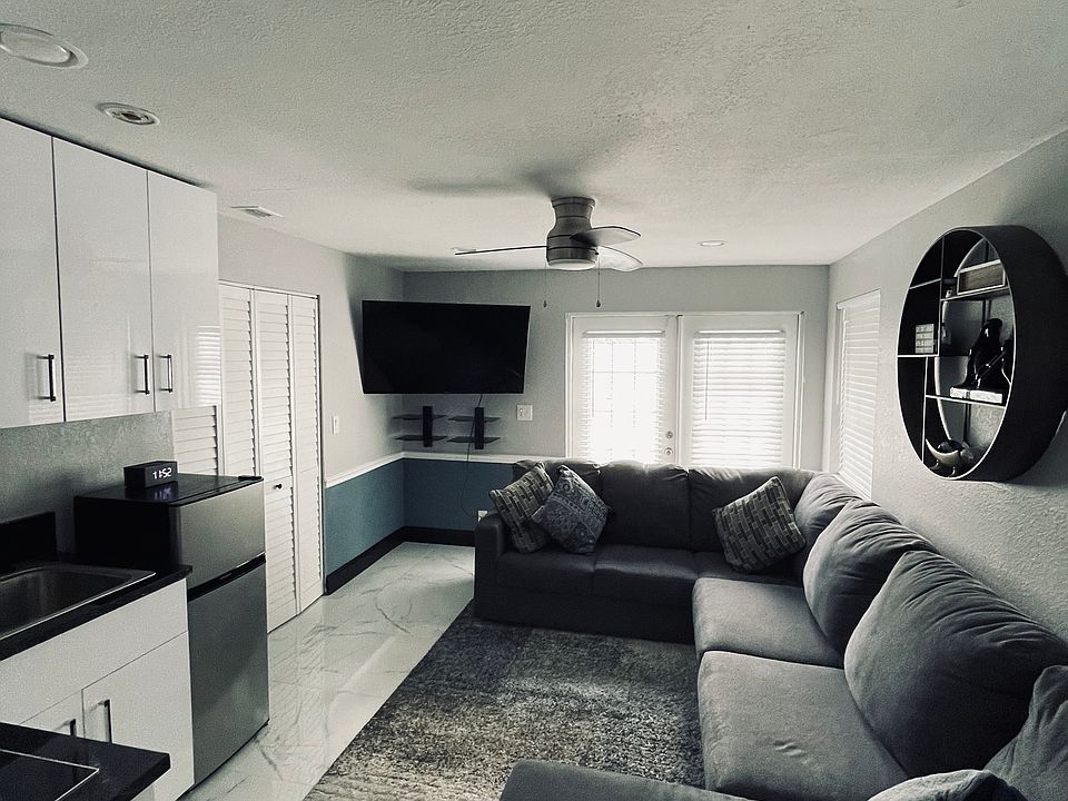 Living room area leading to private entrance to pool